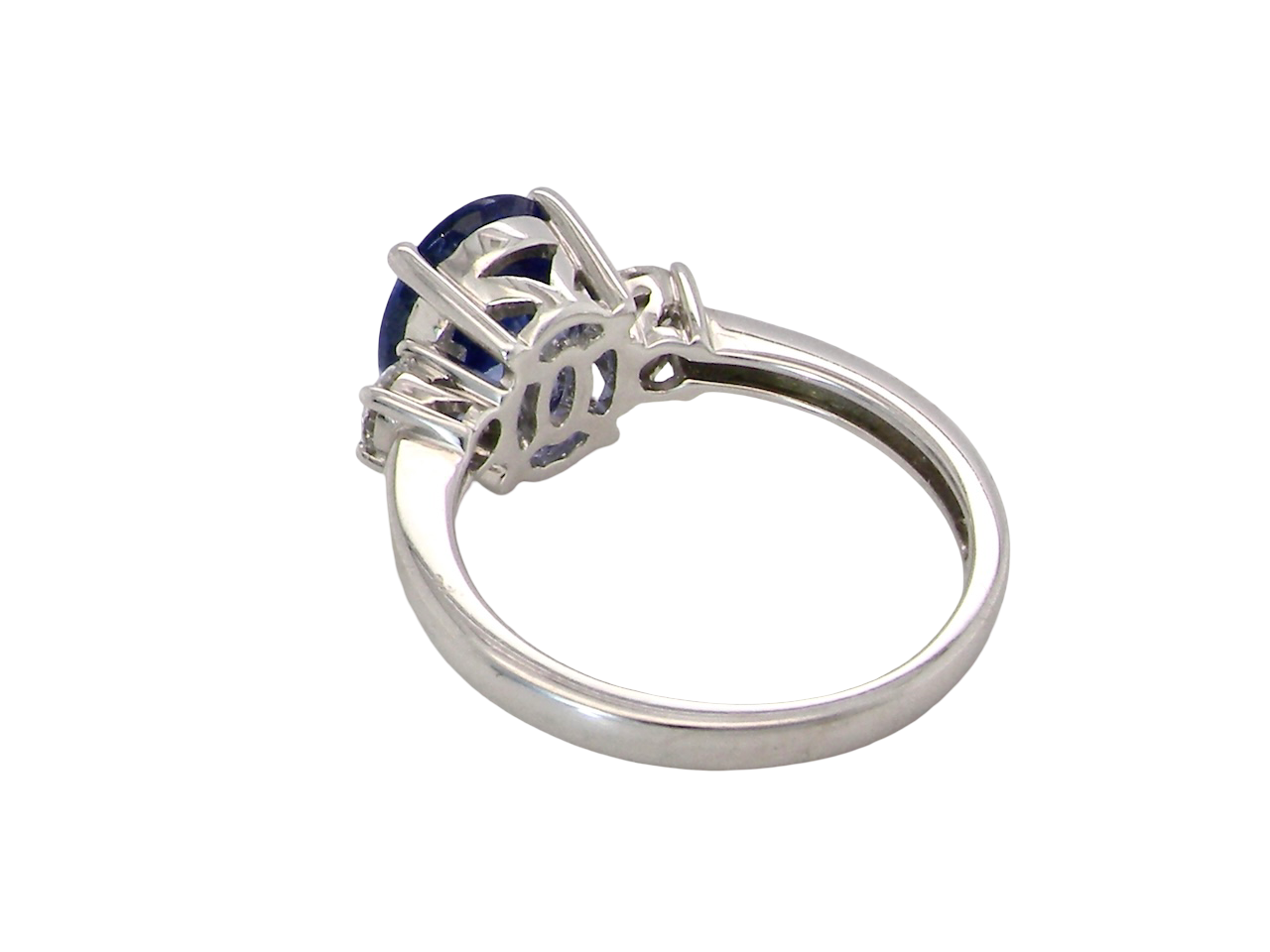 rear A three stone ring that features an impressive tanzanite centre stone that measures 10x8mm (3.21 carats confirmed) AAA colour.&nbsp;