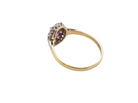rear A traditional cluster ring. Features to the centre a dark pink red ruby, oval cut 6x4mm (0.50 carats)