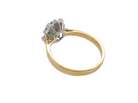 rear A traditional cluster ring. Features to the centre an oval shaped emerald, 5.5x4.5mm (est 0.35 carats) deep green colour.&nbsp;