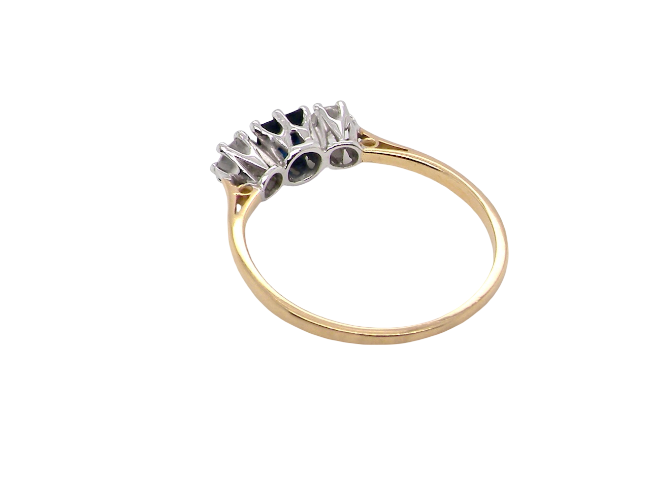rear A vintage 1950s three stone ring. Centre stone an ink black blue sapphire, measures 4x4mm (est 0.30 carats).
