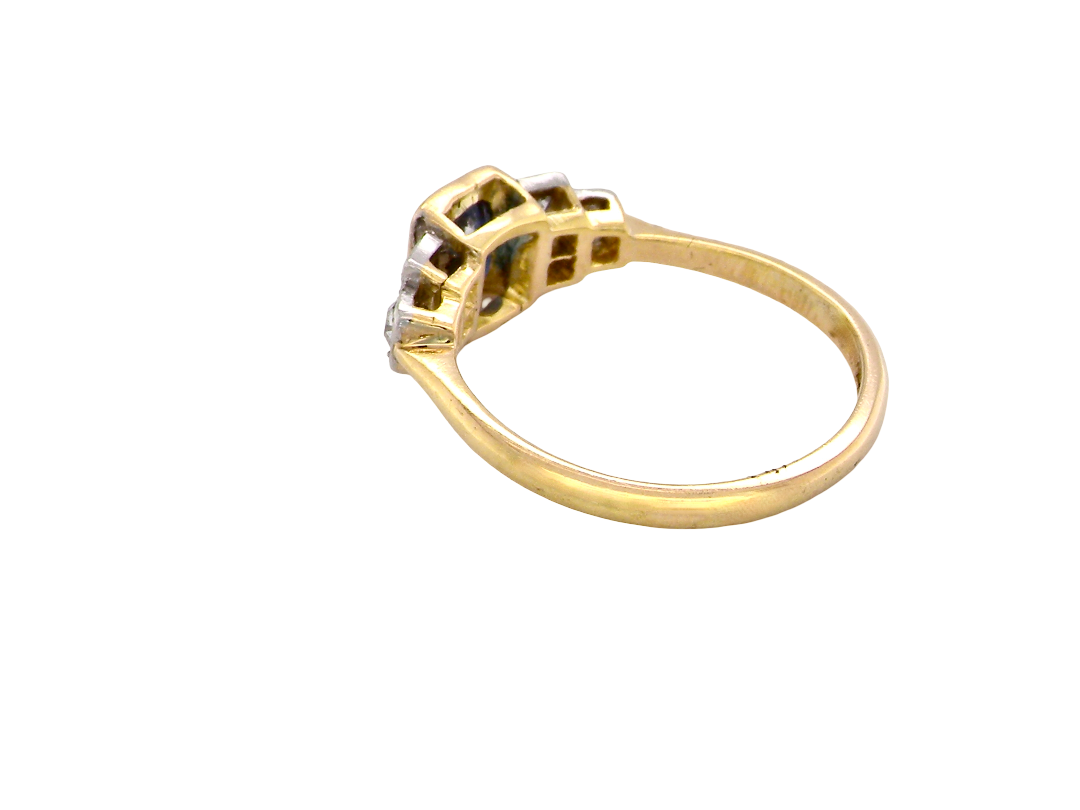 rear A vintage ring that features to the centre a substantial sapphire and to each side set in platinum three small diamonds.