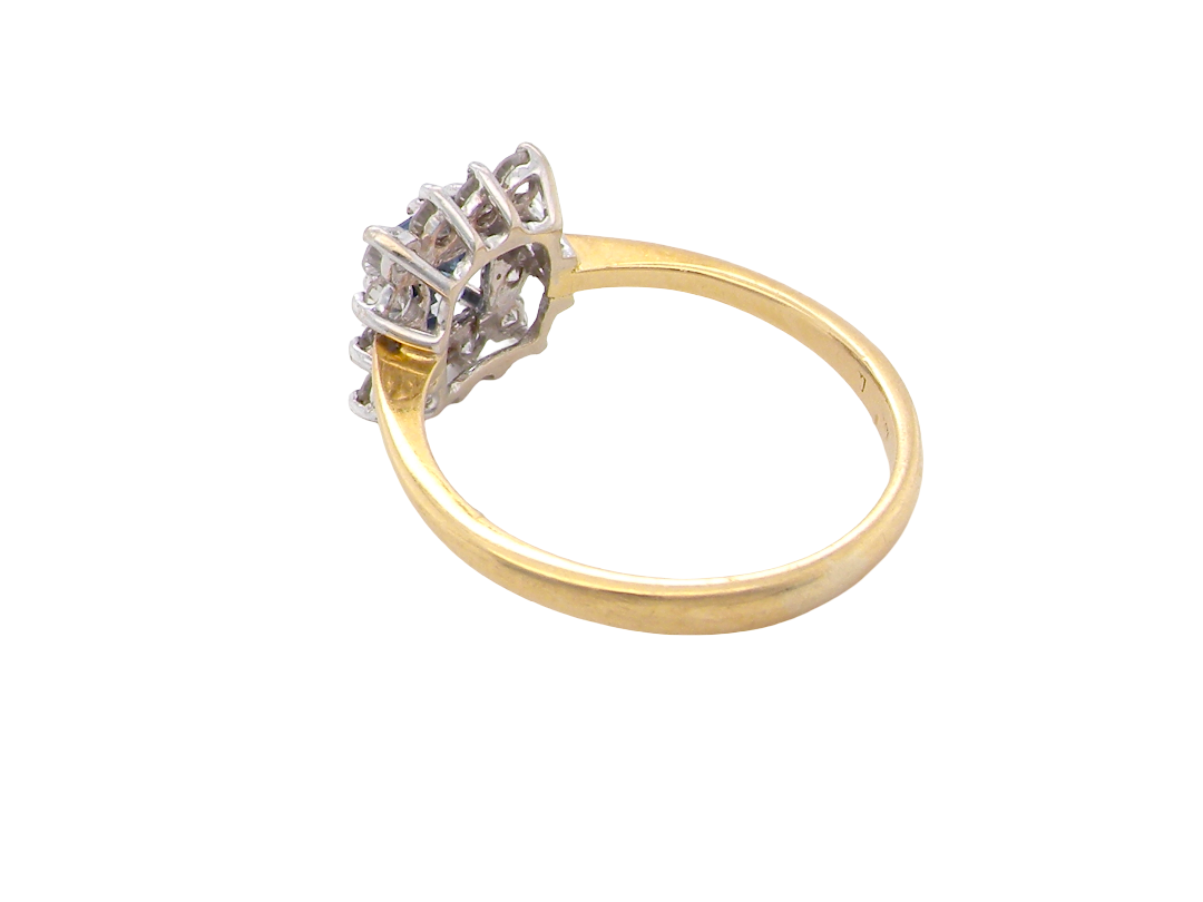 rear A vintage square cluster ring. Features to the centre a square sapphire 5x5mm (est 0.50 carats) mid blue- cornflower hue.&nbsp;
