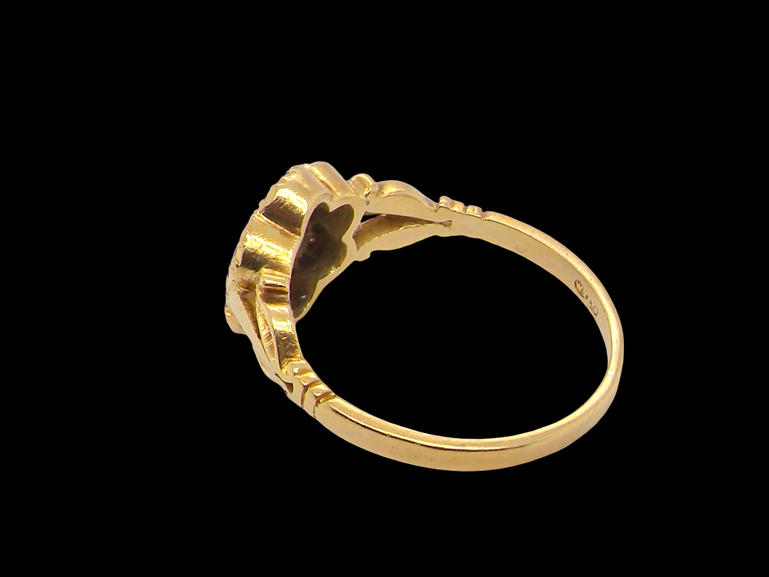 rear An 18 carat gold cluster ring.&nbsp; The centre a floral combination of seven sapphires, each 2.5mm, mid to dark blue.