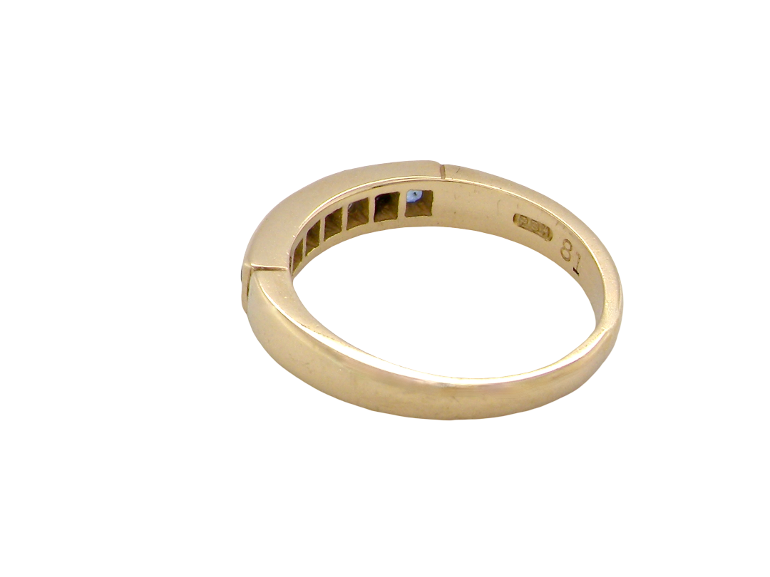 rear An 18 carat gold half hoop eternity ring.

Features four round sapphires , each 2.4mm,