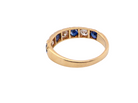 rear An 18 carat gold half hoop eternity ring. Set with four sapphires each 3.4mm (0.15 carats) and three diamonds, brilliant cut, 3.4mm (0.15 carats).