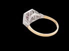 rear An 18 carat gold square cluster that features to the centre a round ruby and an outer halo of brilliant cut white diamonds.
