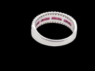 rear An 18 carat white gold half hoop ring. A triple row design with a line of channel set calibre cut rubies running along the centre , to a total carat weight of 0.97 carats.
