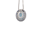 rear An 18 carat white gold oval shaped pendant. Features an oval cut blue topaz centre stone, 13x9mm.

Complimented by an outer halo of approximately thirty small brilliant cut white diamonds,