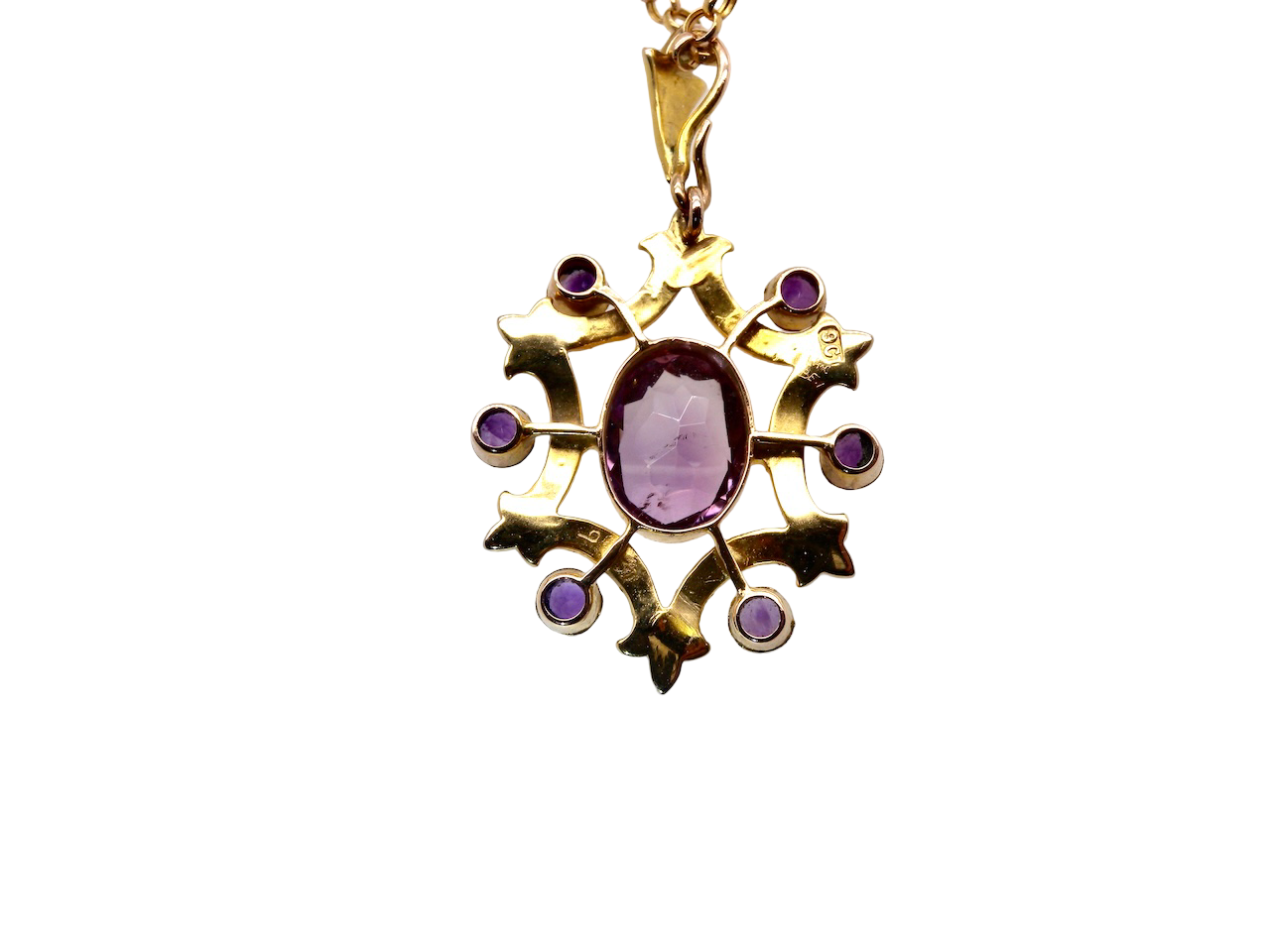 Gold pendant with a purple gemstone on a white background