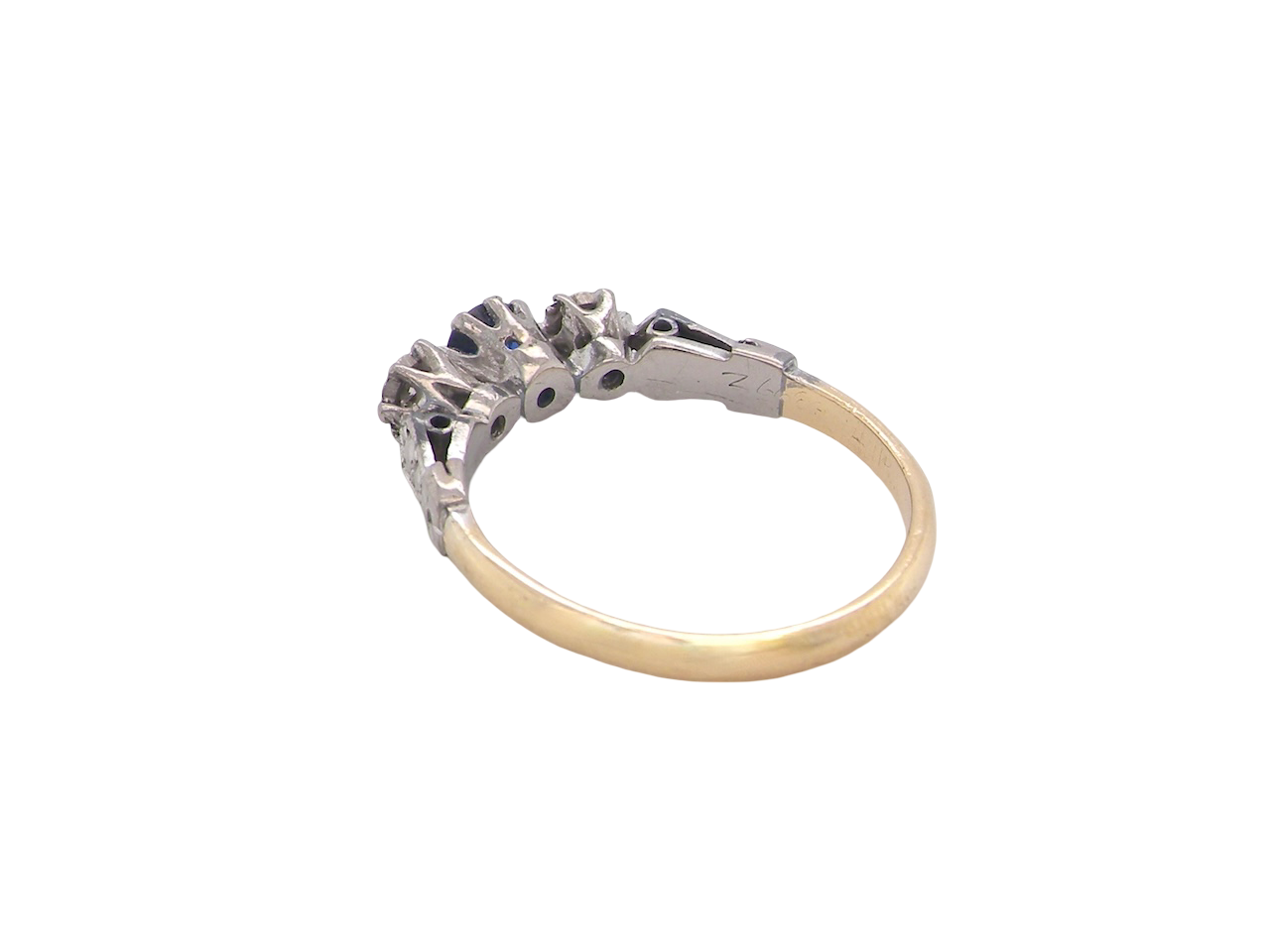 rear An early 20th century engagement ring. The centre stone a dark blue sapphire