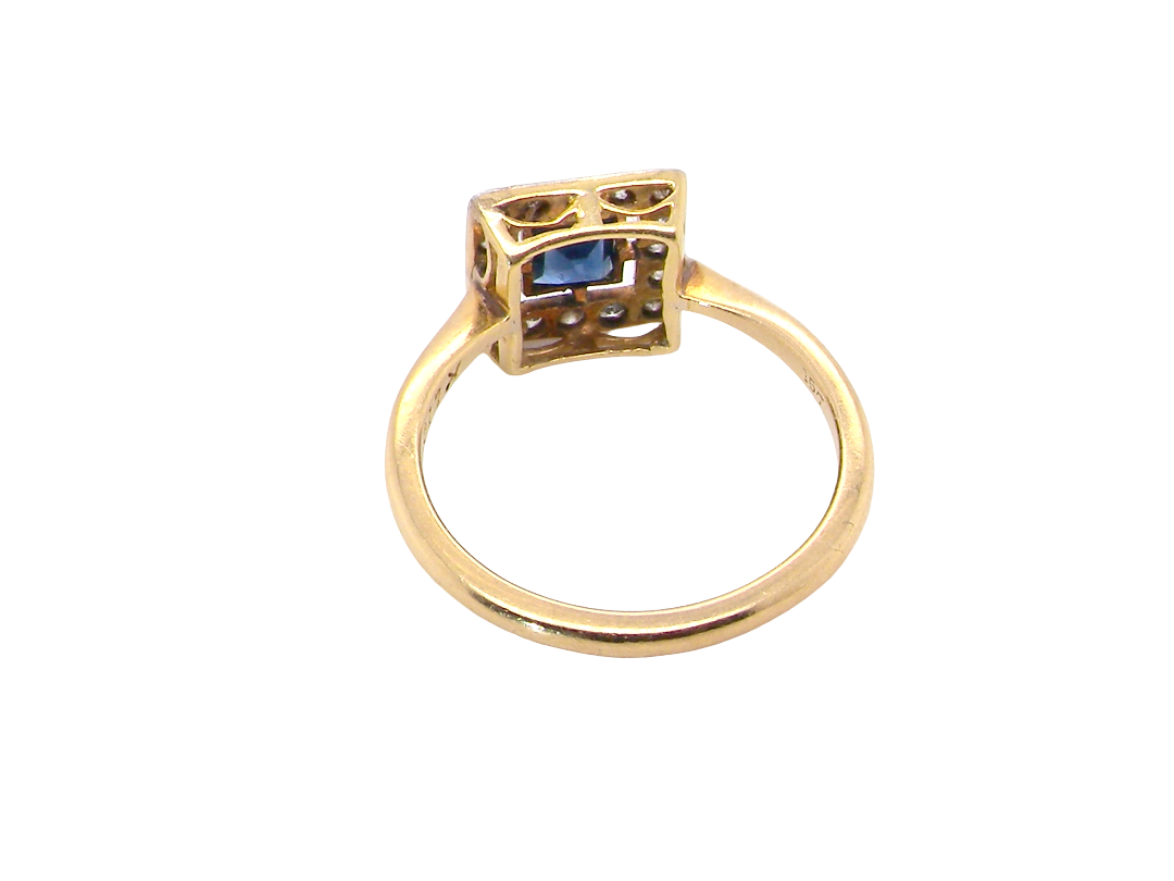 rear An early 20th century square cluster ring. Features a square inky black blue sapphire, 4x4mm (est 0.25 carats) mille grain set.