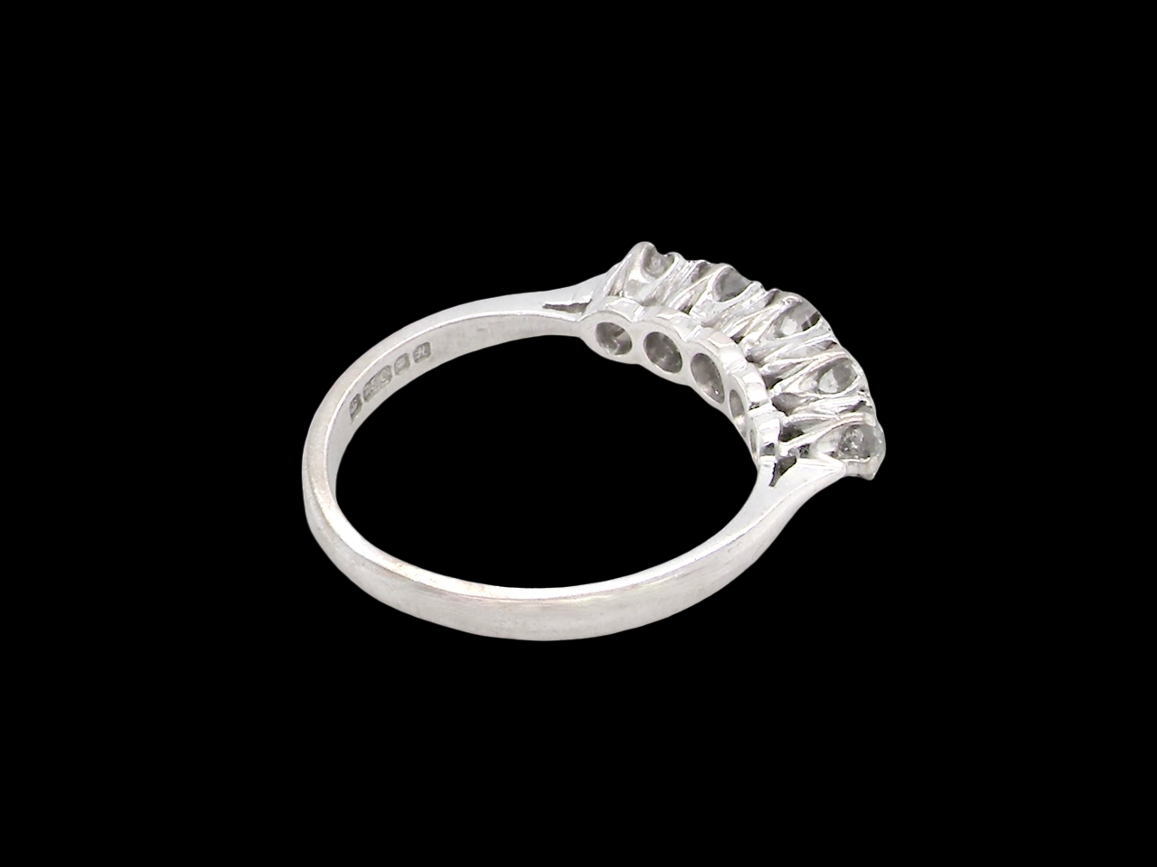 rear An elegant 18 carat white gold five-stone ring set with brilliant-cut white diamonds. The centre diamond measures 3.4mm, flanked by two 3.0mm stones and finished with 2.8mm diamonds at each end, creating a beautifully balanced graduated design.