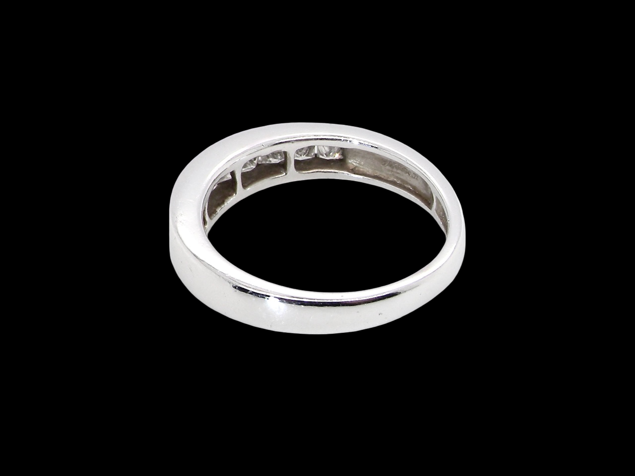 rear An elegant half-hoop eternity ring set with nine princess-cut white diamonds, each measuring approximately 2.5mm, with a total estimated diamond weight of 0.90 carats.