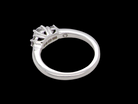 rear An elegant trilogy ring set with three brilliant-cut white diamonds, 