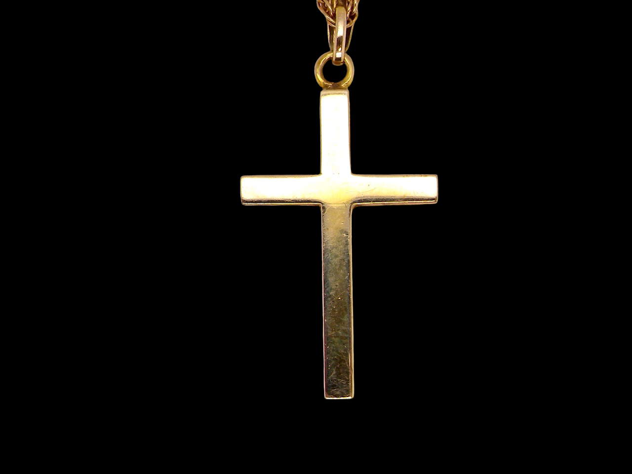An engraved 9 carat gold cross