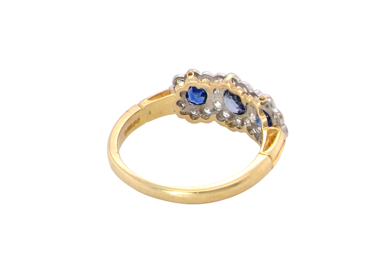 rear An impressive multi cluster ring. Set with three cornflower blue sapphires to each centre, 4.3mm, and each side a 3.3mm sapphire. Based on an Edwardian design
