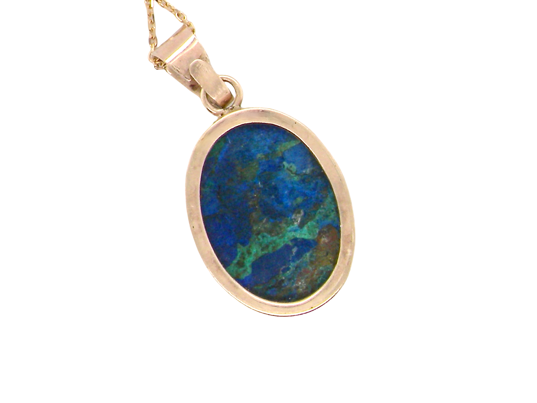 rear An interesting pendant set with an azurmalachite semi precious gem stone. Measures 20x15mm. Gold rim edged setting, with a V shaped bale. (tests as 9 carat gold)&nbsp;