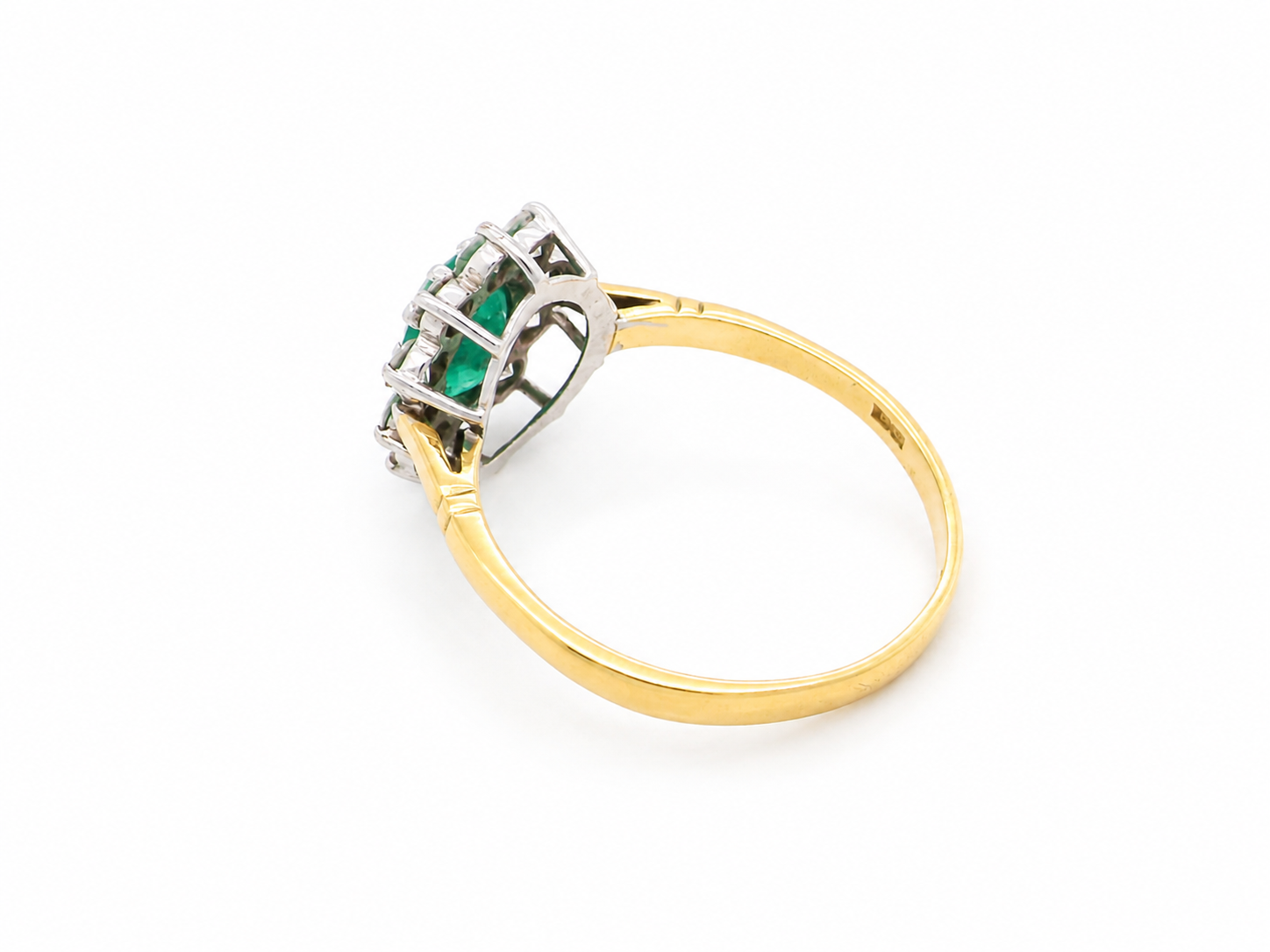 rear Features an oval cut emerald centre stone, vibrant green hues, measures 9x6mm(est 1.75 carats) . Complimented by an outer halo of ten 2.7mm brilliant cut white diamonds (est total 0.60 carats) colour i-j, clarity S.
