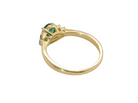 rear Featuring a lovely deep velvety green emerald centre stone, this 18 carat gold ring is enhanced by six brilliant cut white diamonds.