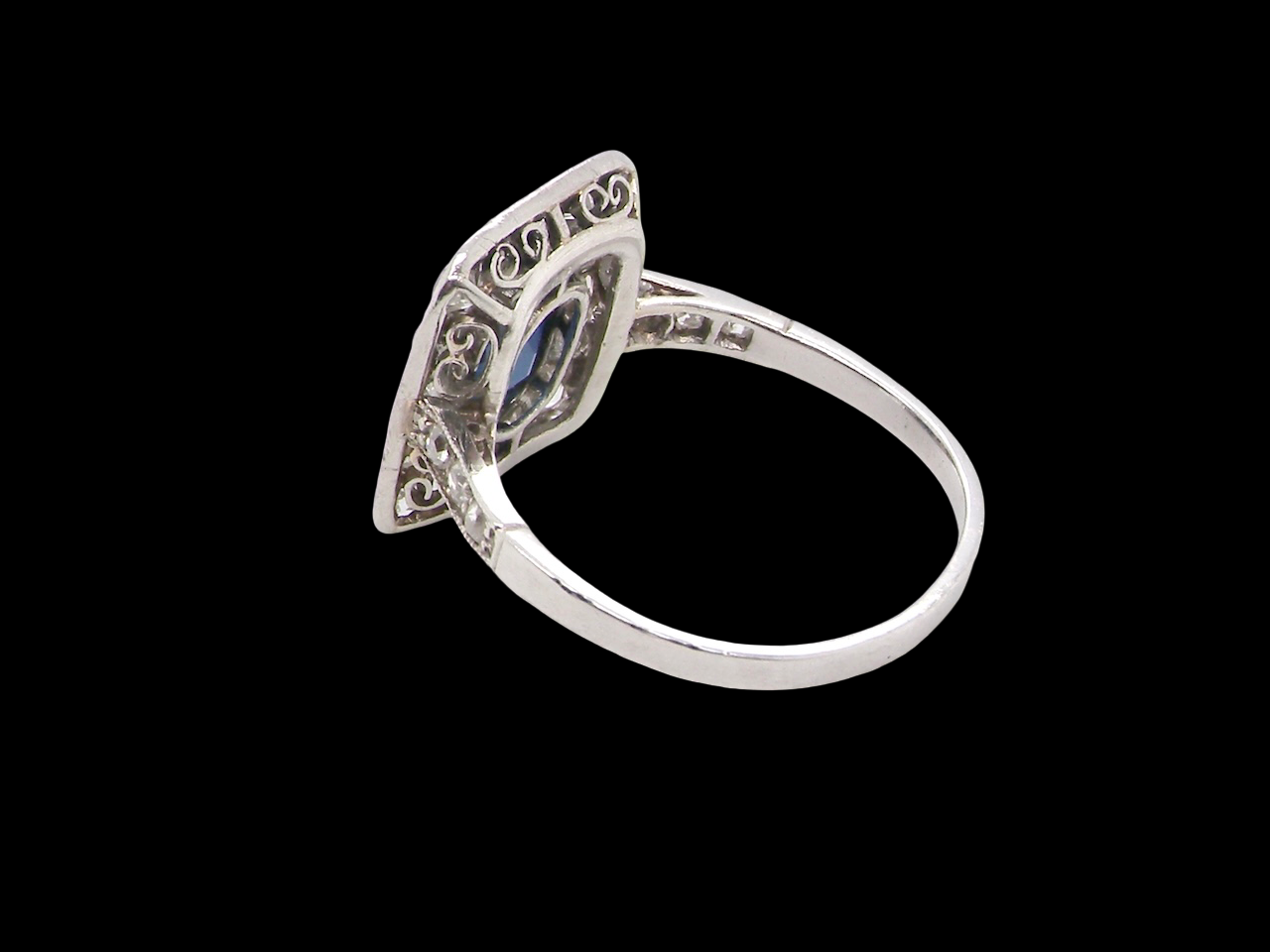 rear beautiful original Art Deco cluster ring featuring a rich, dark blue oval-cut sapphire