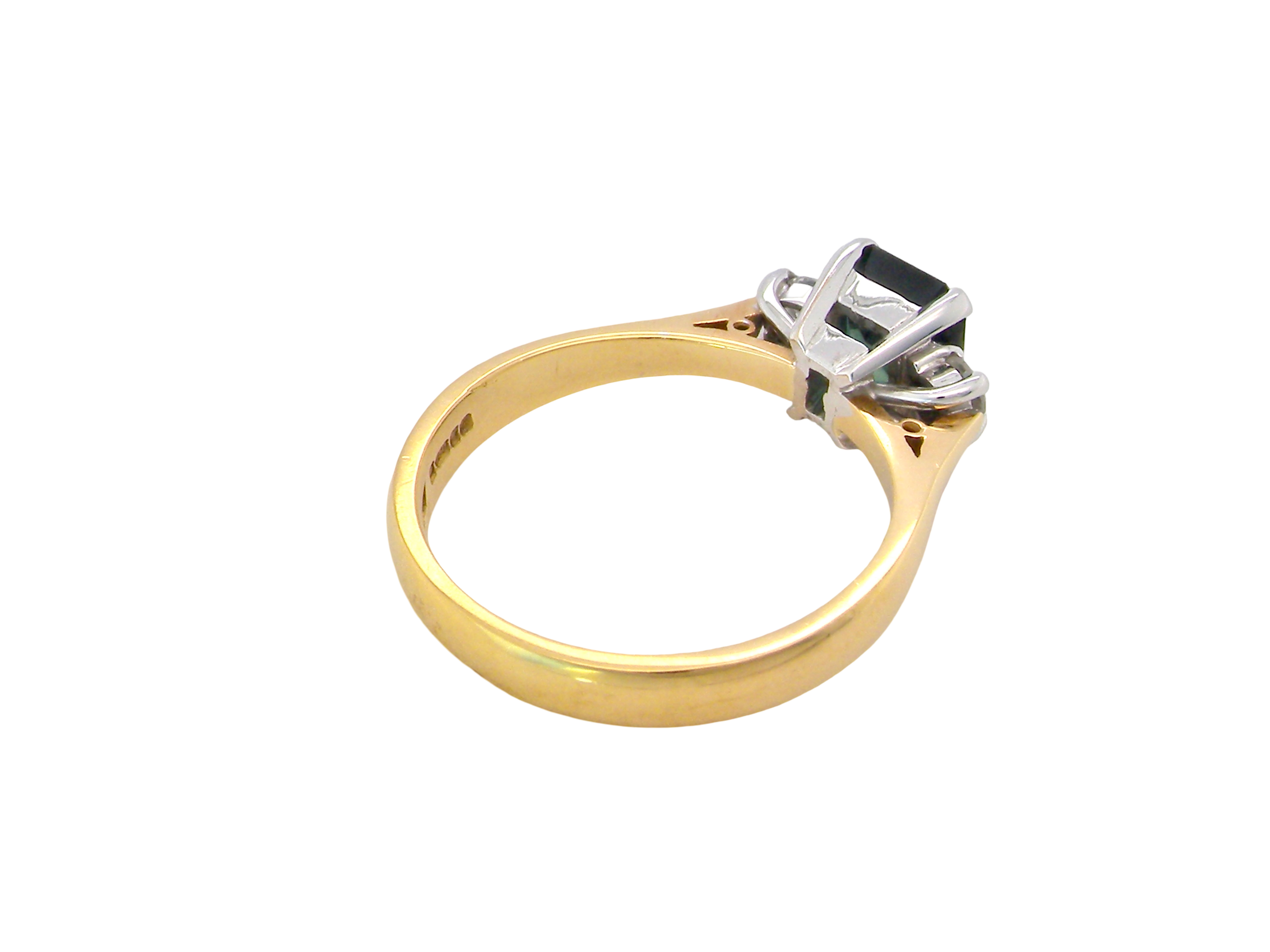 rear elegant 18 carat yellow gold trilogy ring featuring a striking natural sapphire at its centre
