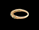 rear half-eternity ring set with alternating emeralds and diamonds.