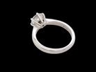 rear  iconic solitaire ring. Features an impressive brilliant cut white diamond. 