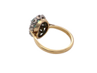rear of  enchanting cluster ring that features at its centre an oval emerald, 