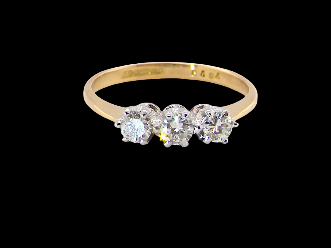  ring is set with three brilliant cut white diamonds, each 3mm diameter. (total estimated at 0.30 carats) Colour h-j, clarity Si. 