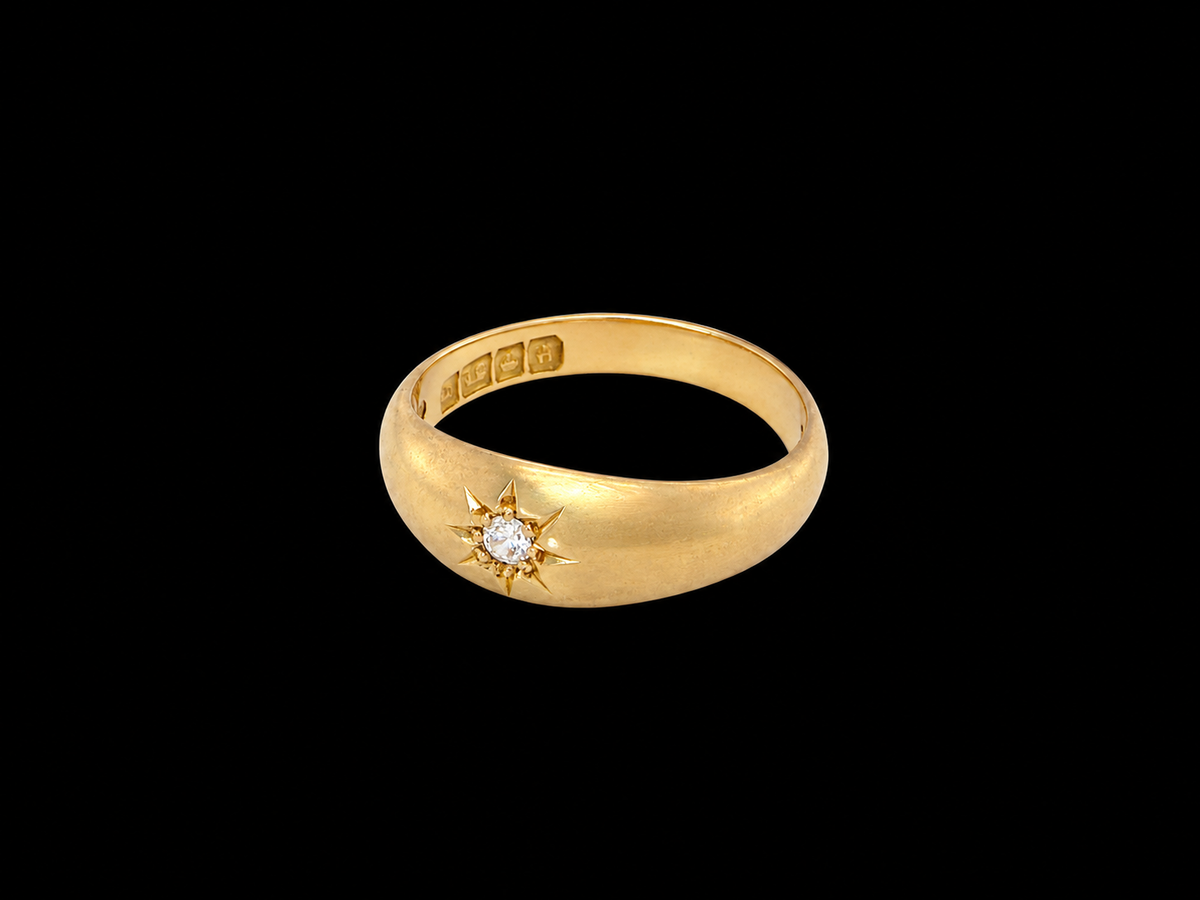side An 18 carat yellow gold ring, sometimes referred to as a 'gypsy' ring. The diamond measures 2.4mm (0.05 carats) star set.