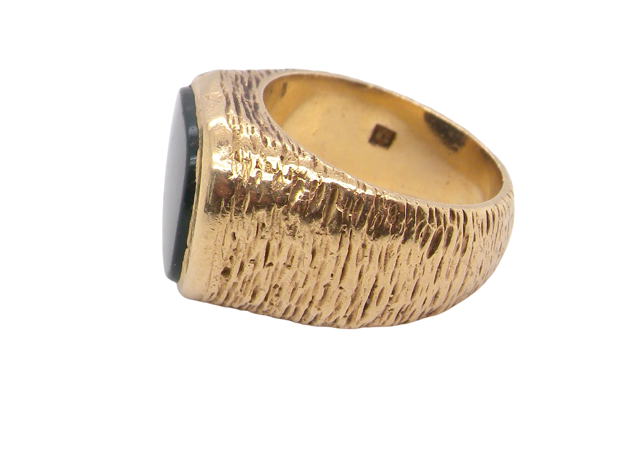 Gold ring with a textured band and black gemstone on a white background