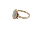 side A 9 carat gold dress ring that features an oval shaped opal. Measures 12x6.7mm, with a&nbsp; very good play of colour across the white background. Mille grain setting
