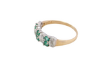 side A 9 carat gold half hoop ring. Set with six round emeralds 3mm each,(total 0.35 carats est) and interspaced with vertical white gold sections each set with 1mm diamonds.(0.05 carats est)