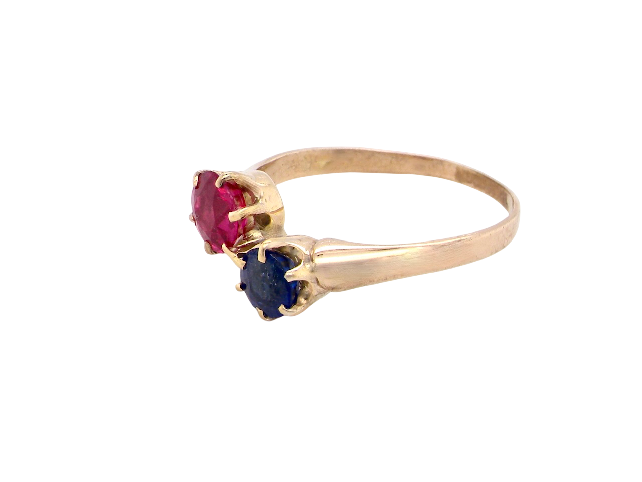 Gold ring with red and blue gemstones on a white background