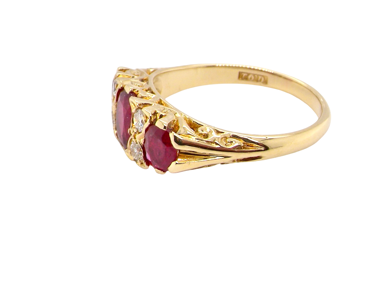 Gold ring with red gemstones on a white background