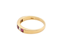 An 18-carat gold half-hoop eternity ring set with alternating rubies and diamonds. 