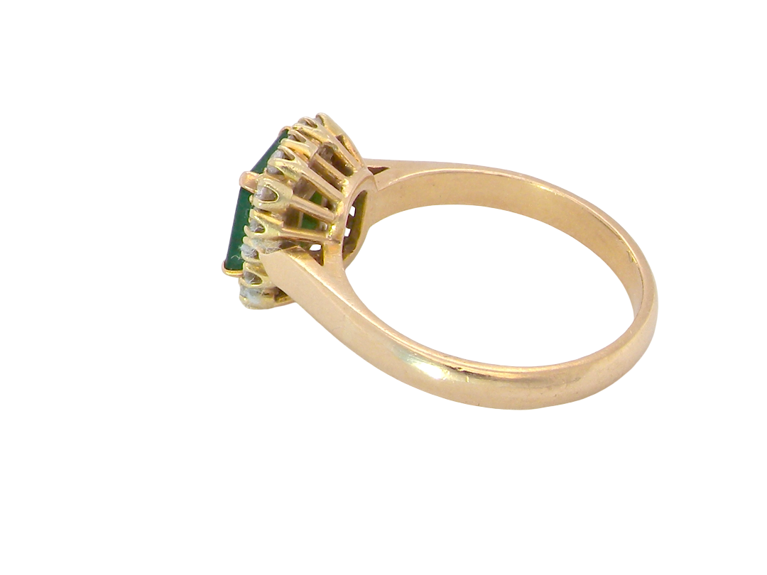 side A beautiful cluster ring set with a large square-cut emerald measuring approximately 7 x 7mm, displaying a deep grass-green colour with natural inclusions, as expected in emeralds.