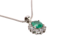 side A beautiful traditional cluster pendant featuring a vibrant oval-cut emerald 