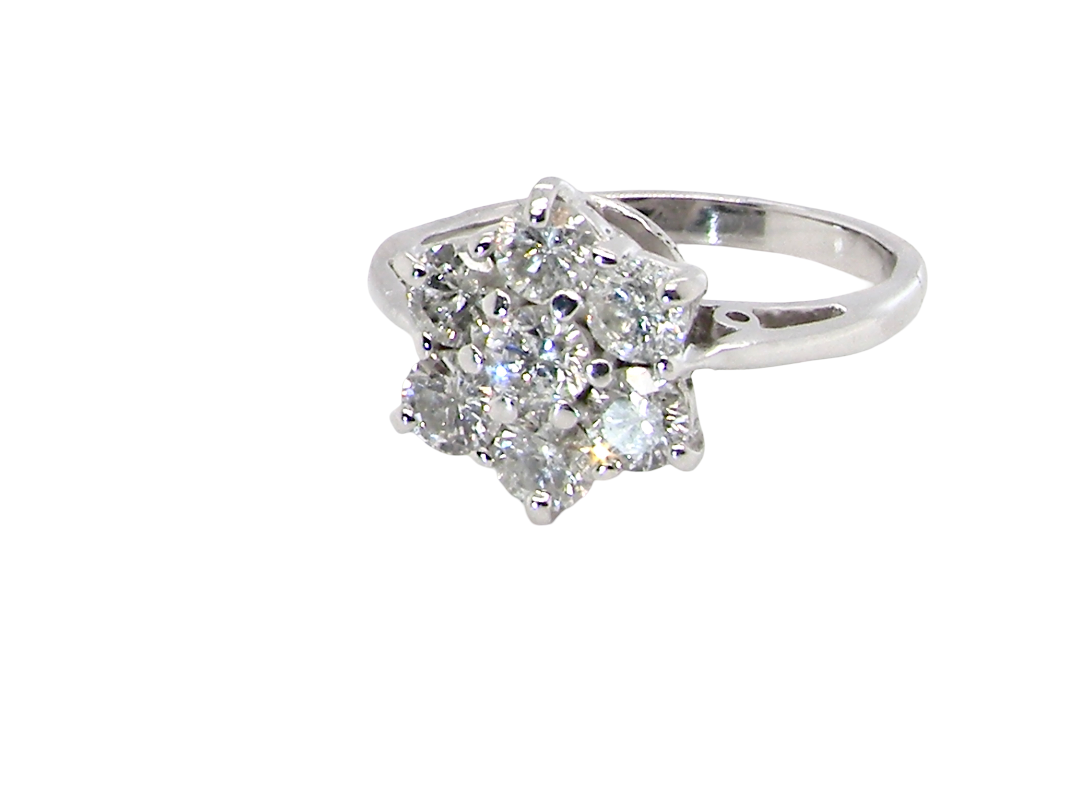 side A beautiful vintage diamond cluster ring, elegantly set with seven brilliant-cut white diamonds in a timeless floral cluster design.
