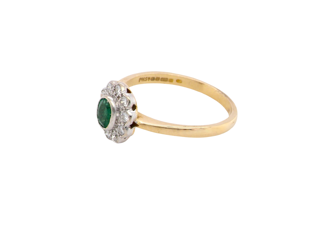 side A beautifully elegant cluster ring featuring a central oval-cut emerald, measuring 5 x 4mm (estimated 0.40 carats).