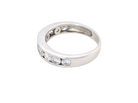 A silver band ring featuring a row of clear oval-cut gemstones along the front, photographed on a plain white background.