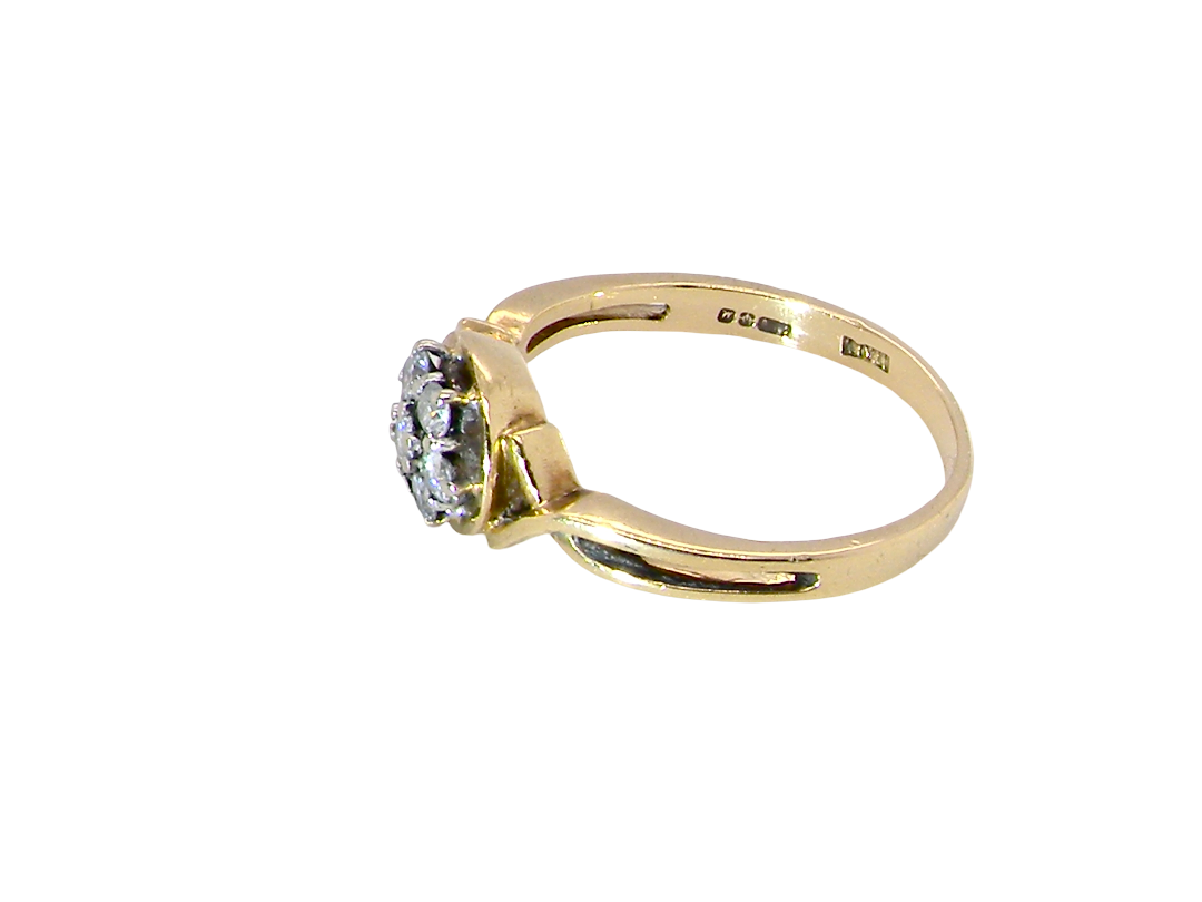 side A classic 1980s cluster ring. Seven brilliant cut white diamonds , each 2.5mm (est 0.40 carats). Colour i-j, clarity Si. Claw set in white gold.