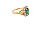 side A cluster ring that features a rectangular emerald centre stone, 7x5mm . Deep green colour, natural inclusions that can be seen under an eye glass, but not easily visible via the naked eye.