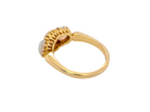 A gold ring with a textured, scalloped setting holding a round white opal gemstone, shown on a plain white background.