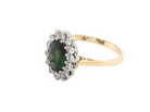 side A fine and impressive vintage cluster ring, centred with a striking oval-cut deep dark green tourmaline, measuring 9 x 7mm and estimated to weigh approximately 2.00 carats.