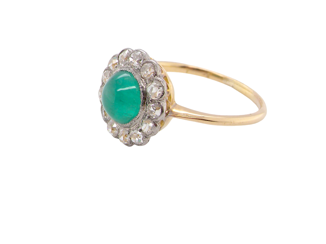 side A fine antique cluster ring. The centre stone a cabouchon cut emerald