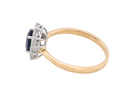 side A fine cluster ring that features a black blue oval cut sapphire that measures 7x5mm (est 0.75 carats)
