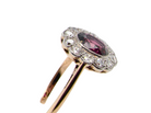 side A fine early 20th century cluster ring featuring to the centre an oval ruby, 6x5mm, deep burgundy red colour, mille grain setting. (est 1.02 carats)

