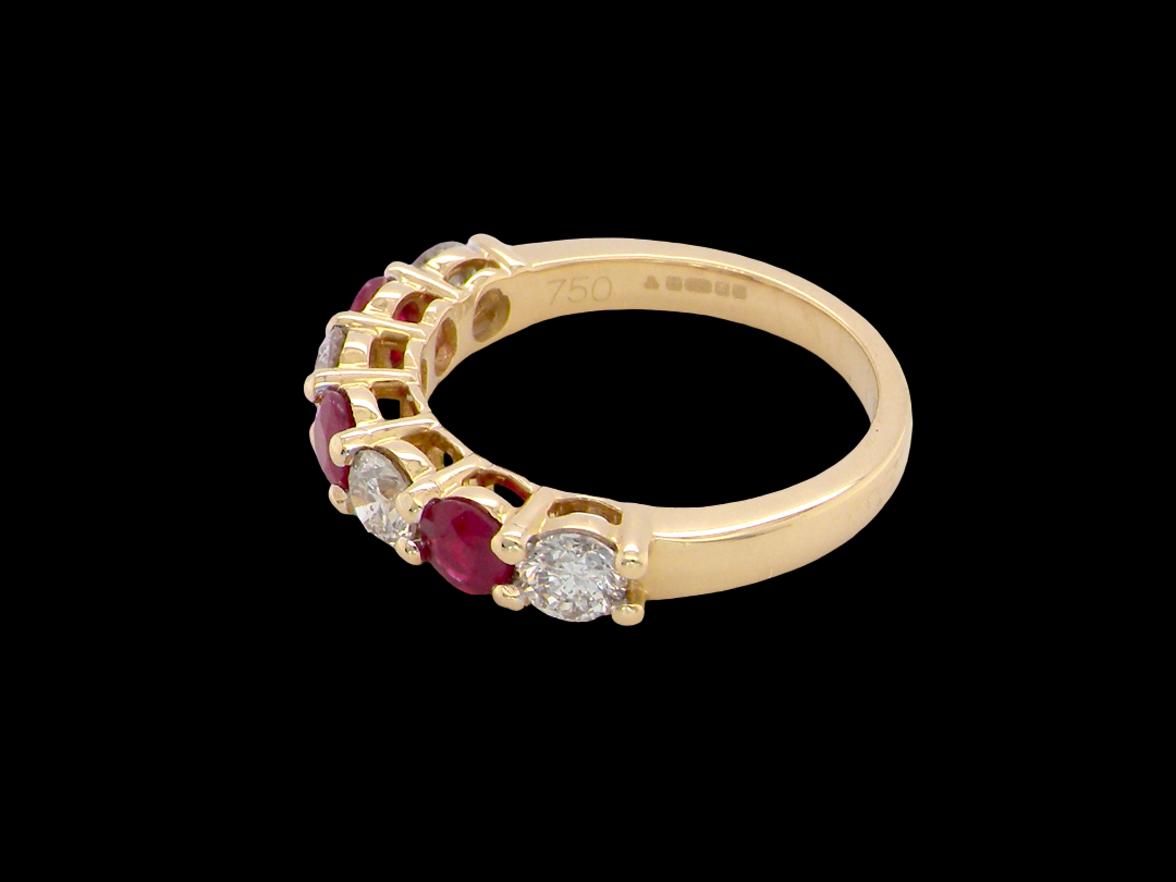side A fine half hoop ring. 18 carat gold set with three rubies, each 3.8mm (est 0.20 carats, total 0.67 carats) and four brilliant cut white diamonds, each 3.8mm (total 0.85 carats)&nbsp;
