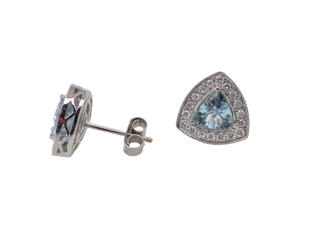 side A fine pair of 18 carat white gold cluster earrings, each containing a trapeze cut aquamarine 6x6x6mm (1 carat) surrounded by eighteen x 0.02 carat brilliant cut white diamonds.